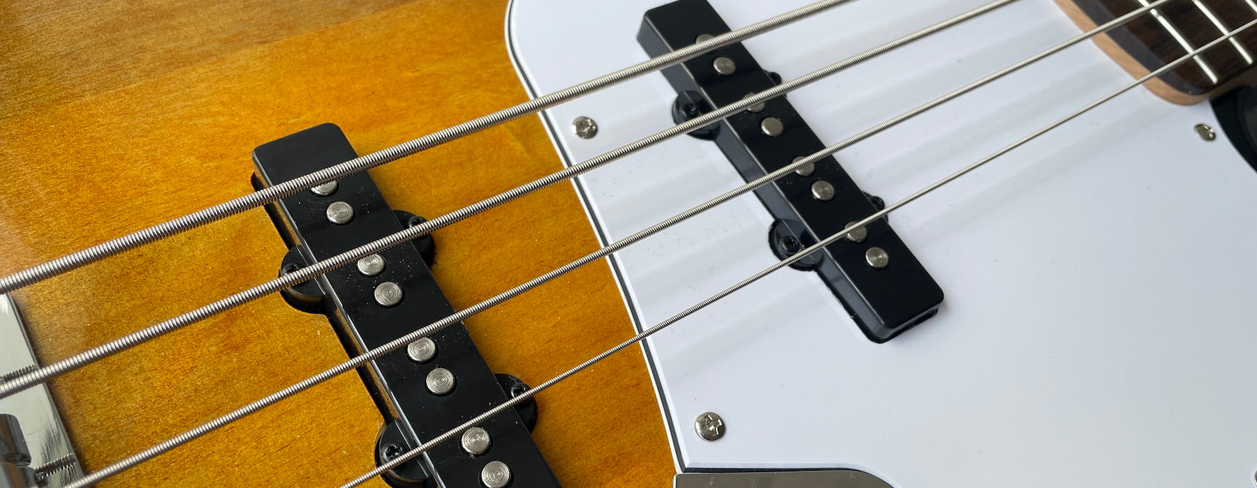 Jazz Bass Pickups on a Fender Squire showing part of pickguard