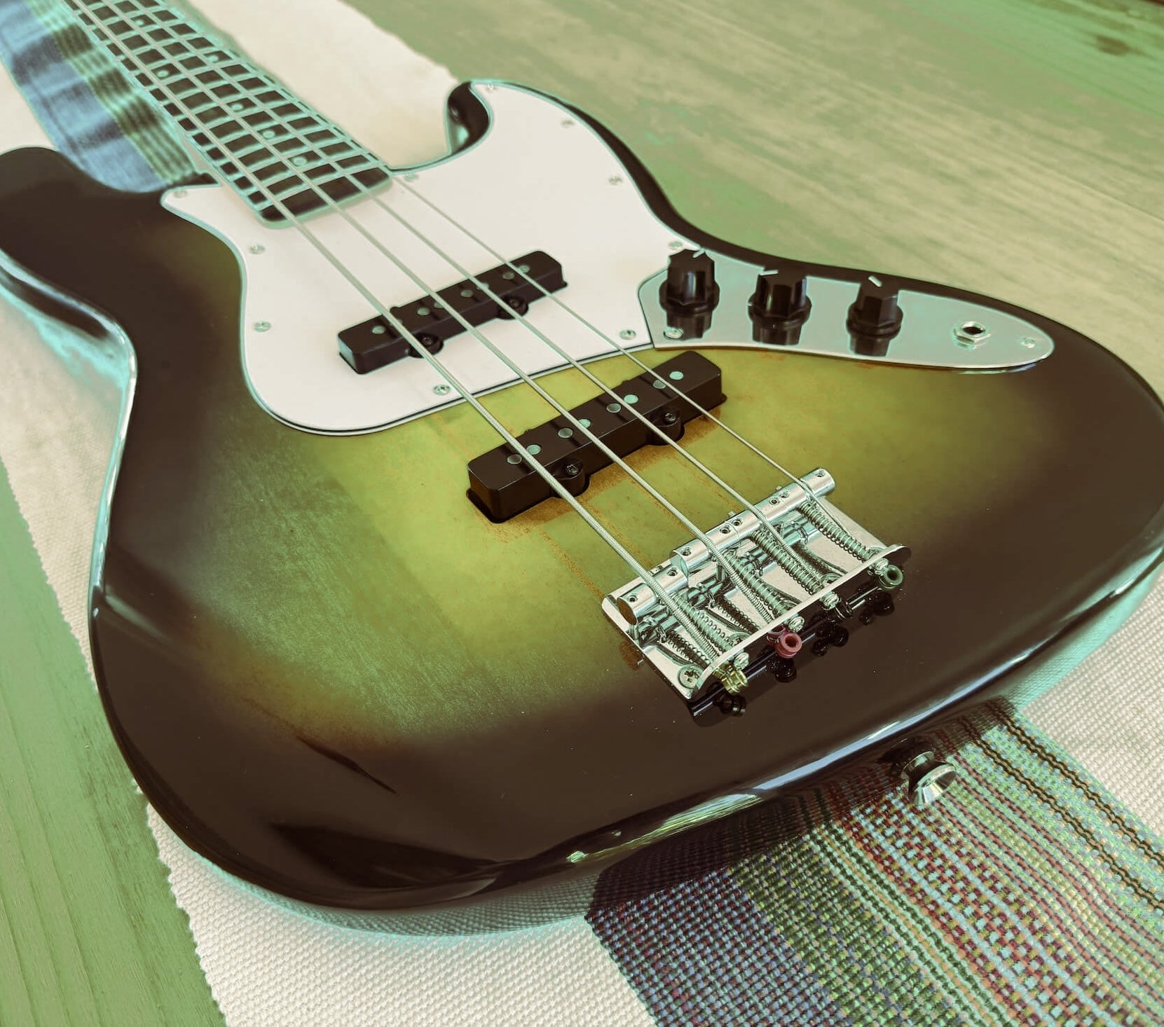 Jazz Bass on table, focused on the body of the bass showing the pickups