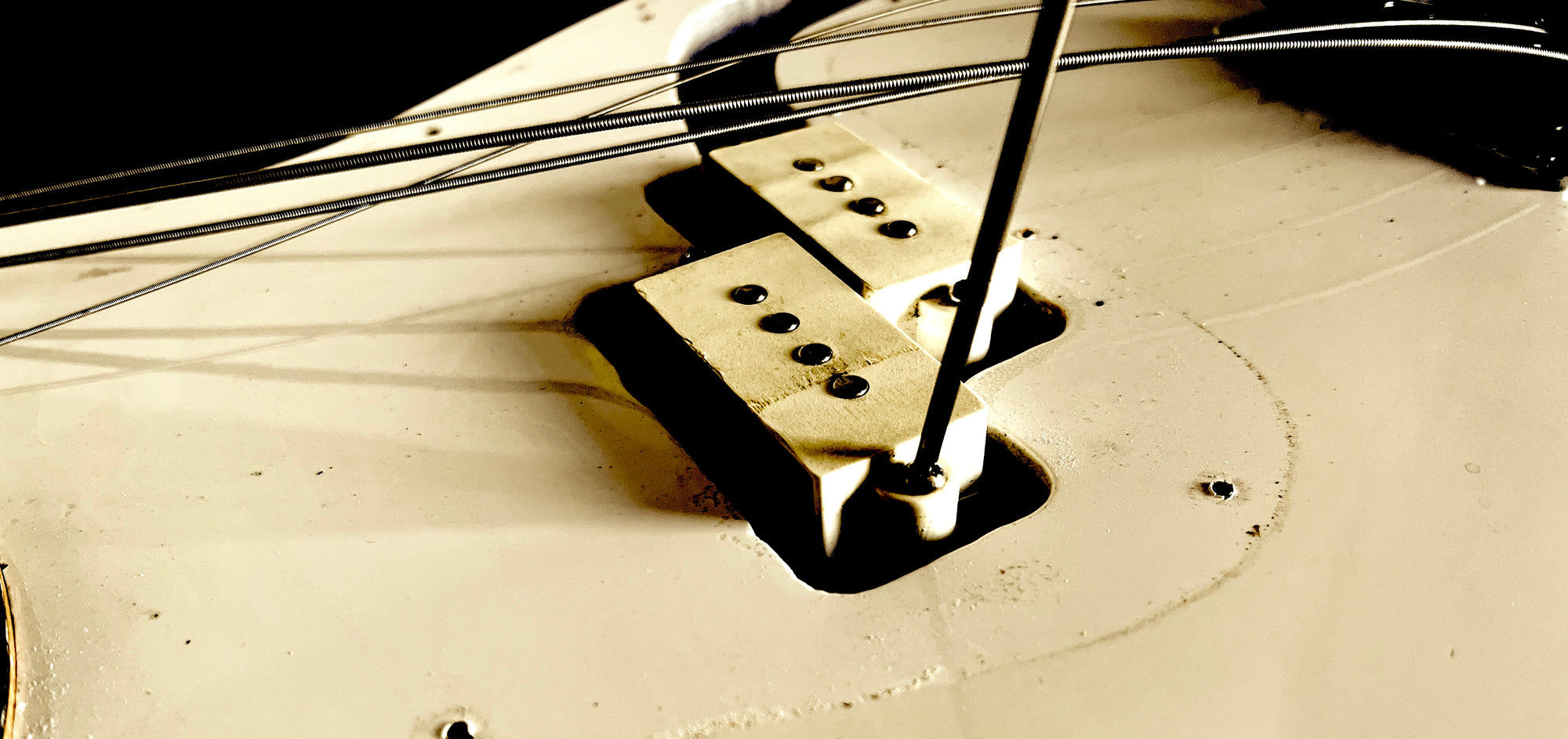 Bass Pickup removal image on a white Fender Precision Bass®
