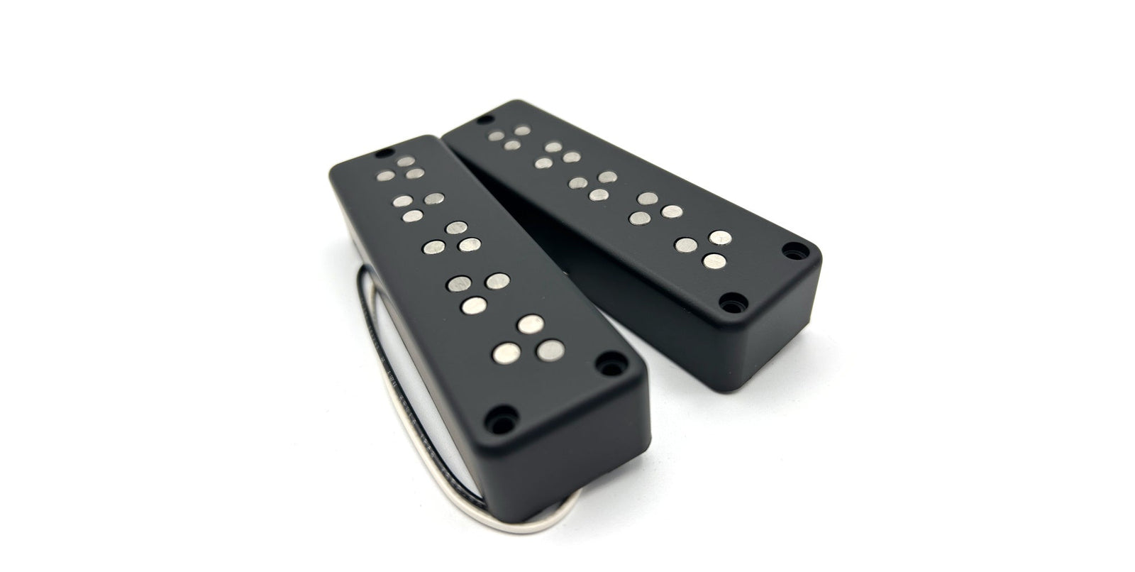 photo of a set of LeCompte Triple Threat Bass Pickups in the P2 soapbar shape, showing the 3 pole pieces per string per pickup