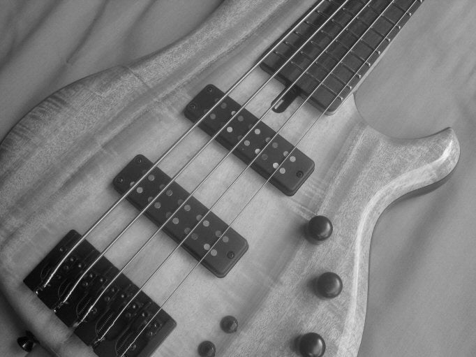 Black and White photo of a 5 string bass guitar body that features p2 shape pickups