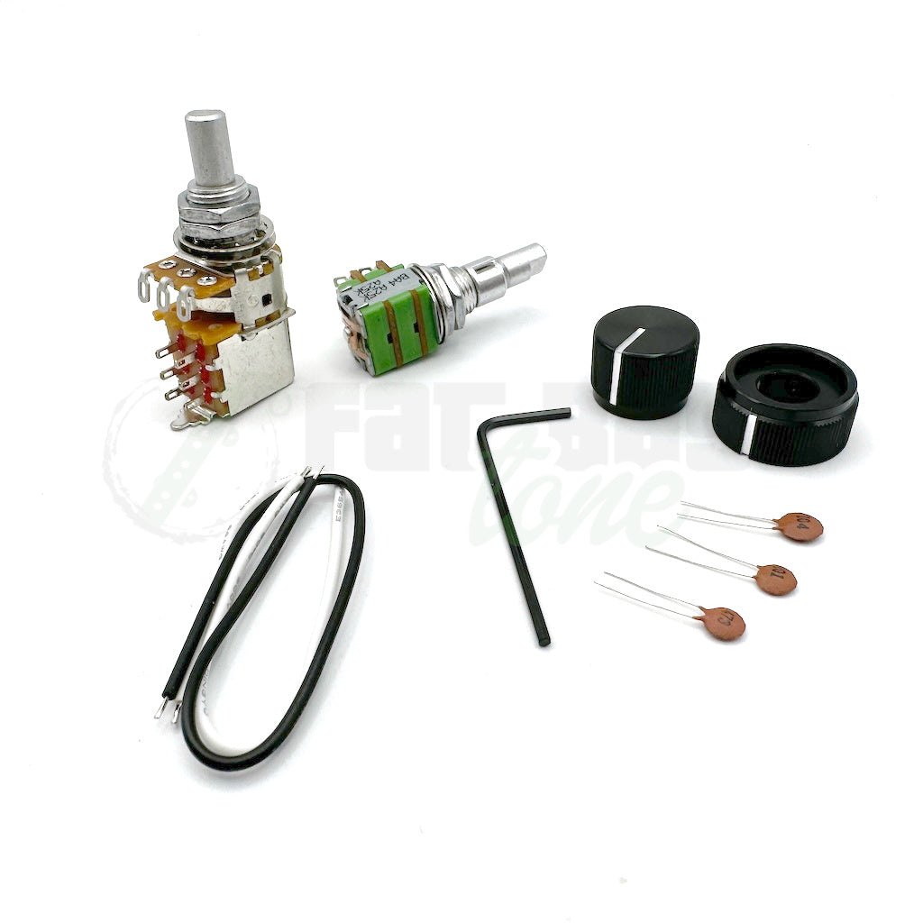 Photo of all included items with the Sadowsky Vintage Tone Control (VTC) Retrofit Kit for Bass including the pushpull volume pot, the stacked tone control, capacitors, allen wrench and black/white wires