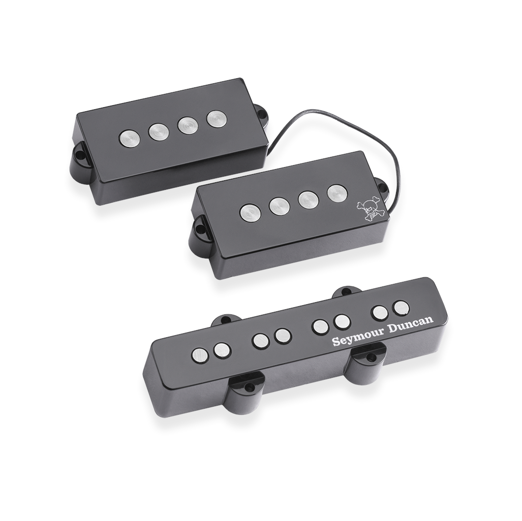 Photo of Seymour Duncan Duff McKagan signature bass pickups, showing the large pole pieces on the P pickup  and J pickup with standard size pole pieces, the P pickup has a small white skull and crossbones logo down in the lower right corner