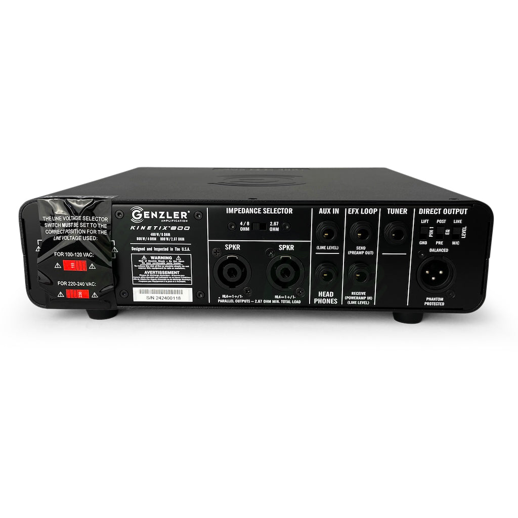 rear view of the Genzler Kinetix 800 Bass Amp, showing tape over the power switch, voltage selector and cord plug, in addition to showing the direct output and other connection ports.
