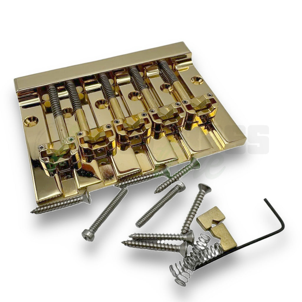 gold version of the Hipshot KickAss Bass Bridge 5 string bridge in the pattern 1 style