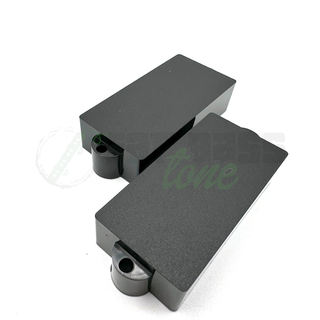 P Bass Pickup Covers in Black showing a smooth top surface without holes for pole pieces