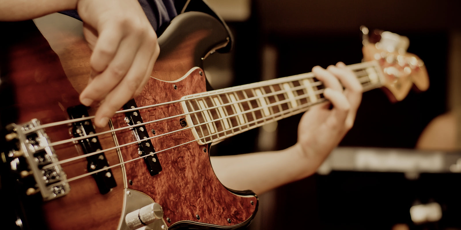 Bass Player playing with a 4 string Fender Jazz Bass®