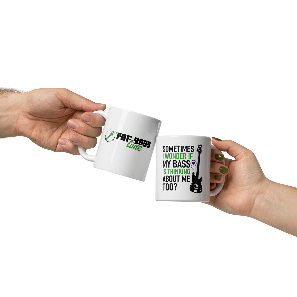 Two white mugs with text and graphics held by hands against a white background